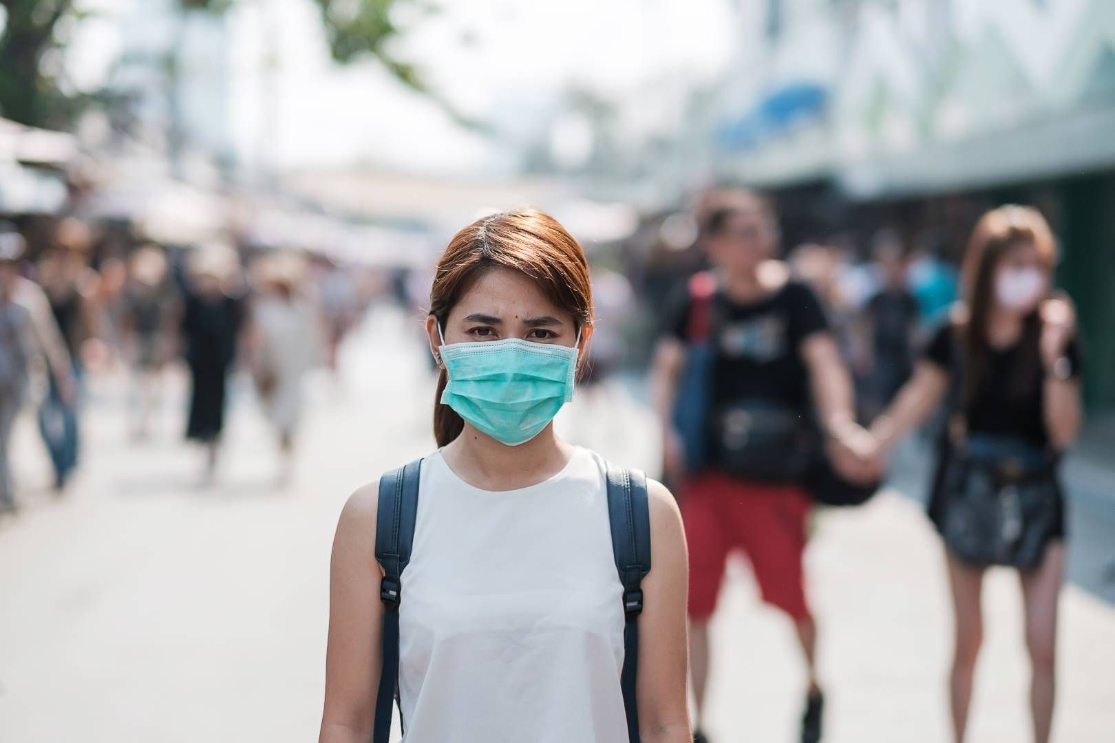 joven con mascarilla Joven asiática con máscara de protección contra el nuevo coronavirus (2019-nCoV) o el coronavirus Wuhan en el mercado de fin de semana de Chatuchak, punto de referencia y popular para las atracciones turísticas en Bangkok, Tailandia