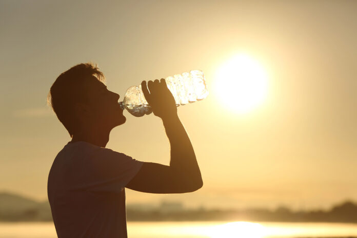 alerta amarilla por calor en euskadi foto de una persona bebiendo agua bajo un sol y calor foto de depositphotos